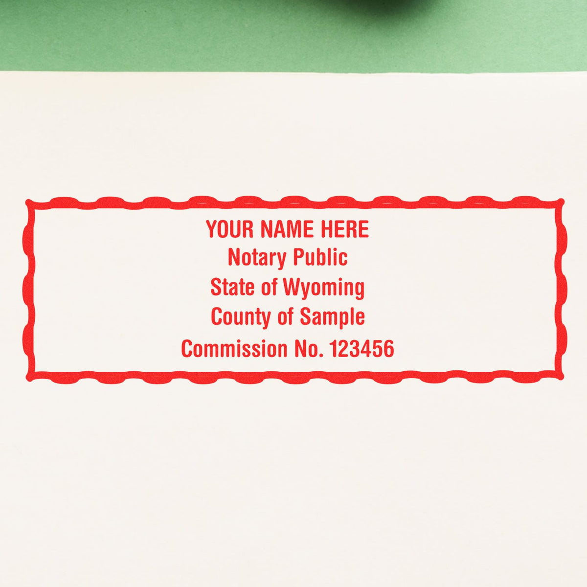 An alternative view of the MaxLight Premium Pre-Inked Wyoming Rectangular Notarial Stamp stamped on a sheet of paper showing the image in use