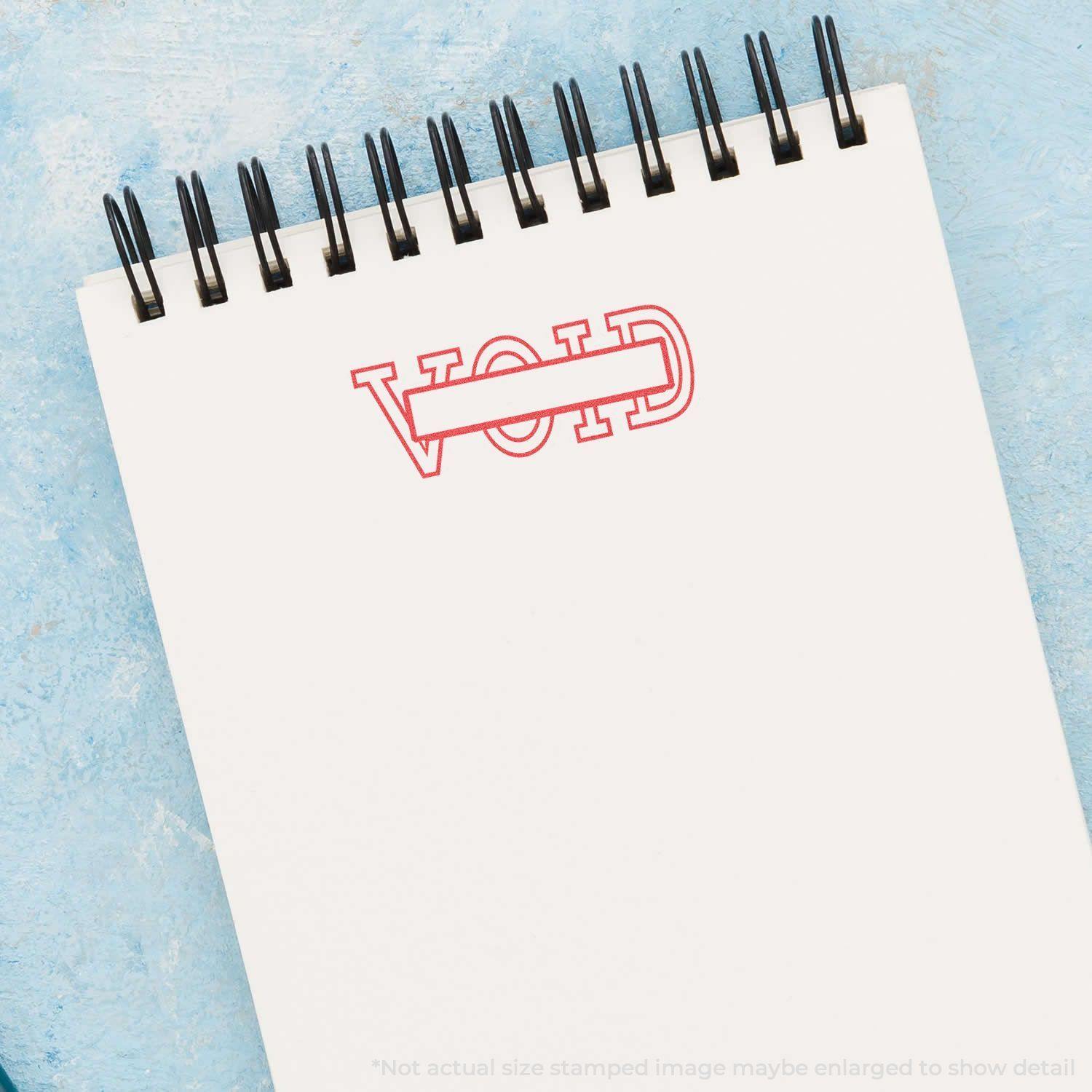 Notebook with a red 'VOID' stamp impression using the Date Void Xstamper Stamp on a blue background.