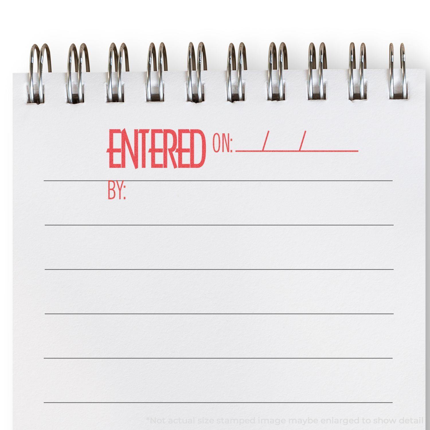 Notebook with 'ENTERED ON: ___ BY: ___' stamped in red using Xstamper Stamp, showing blank lines for filling in information.