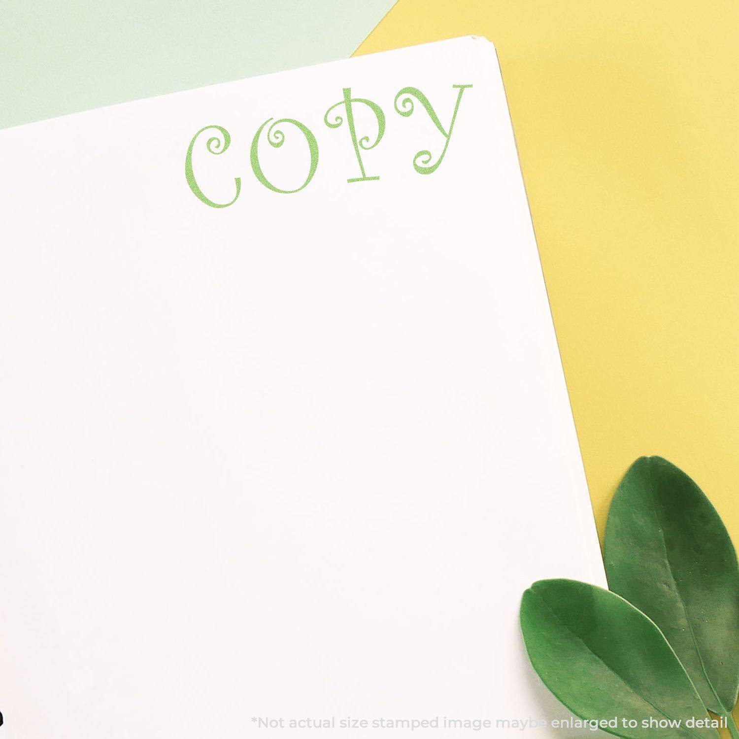 Green Copy Xstamper Stamp imprinting the word COPY in green ink on white paper, with green leaves and yellow background.