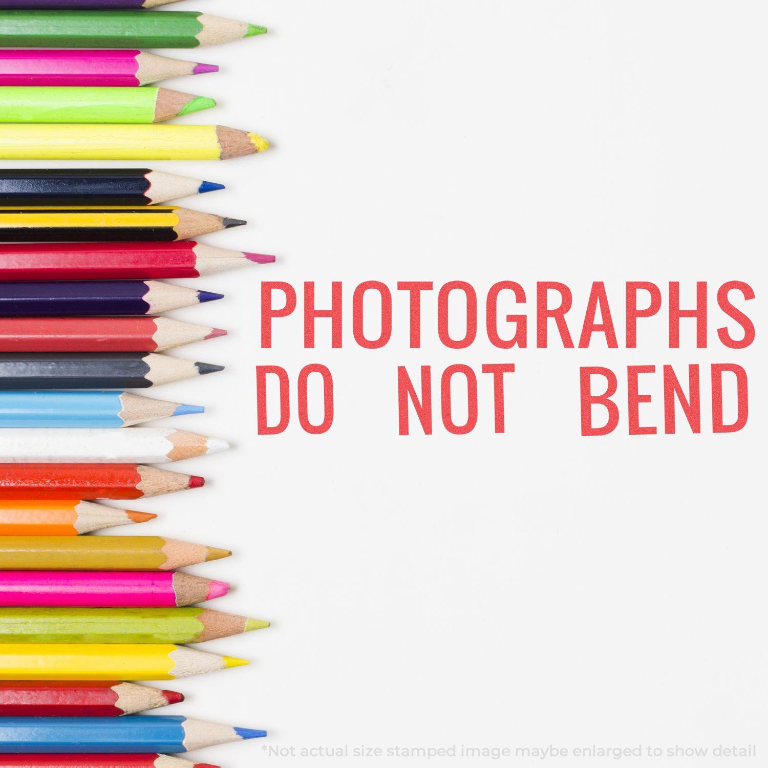 Colorful pencils next to red stamped text PHOTOGRAPHS DO NOT BEND using the Jumbo Photographs Do Not Bend Xstamper Stamp.