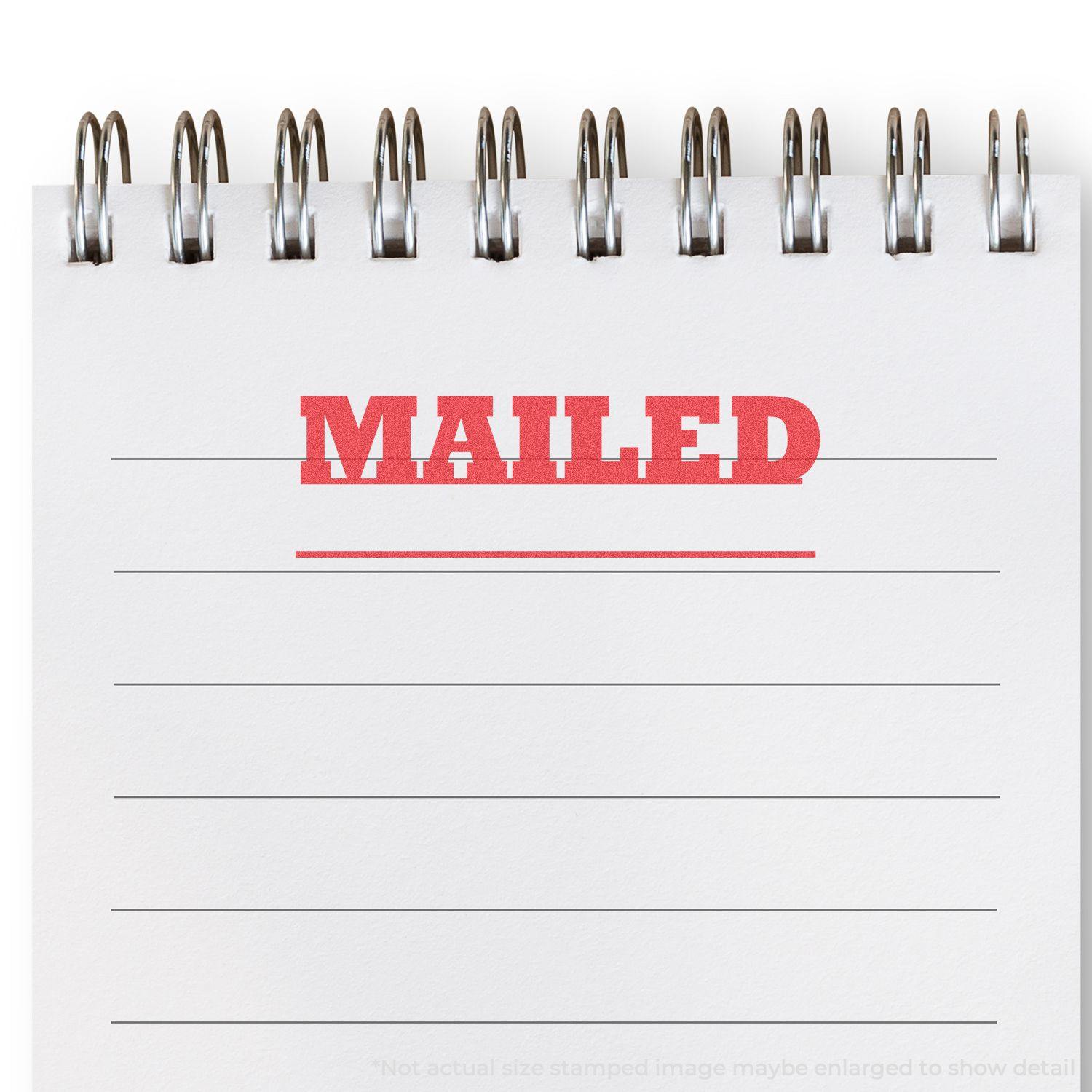 A Mailed Xstamper Stamp imprint in red ink on a white notepad with lined paper, showing the word MAILED in bold uppercase letters.