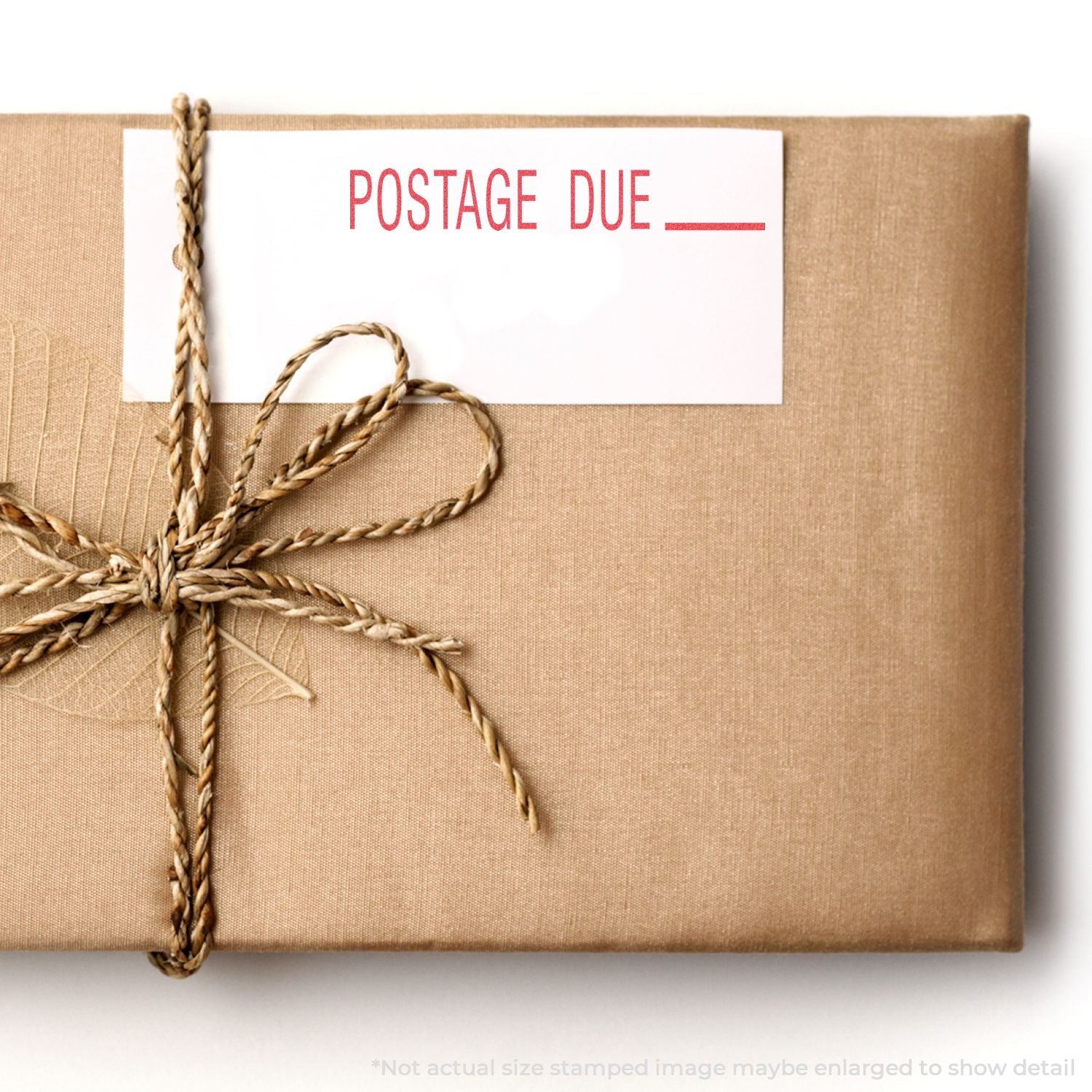 A brown wrapped package with a POSTAGE DUE label stamped using the Custom Self Inking Stamp Trodat 4912 Size 3/4 x 1-7/8.