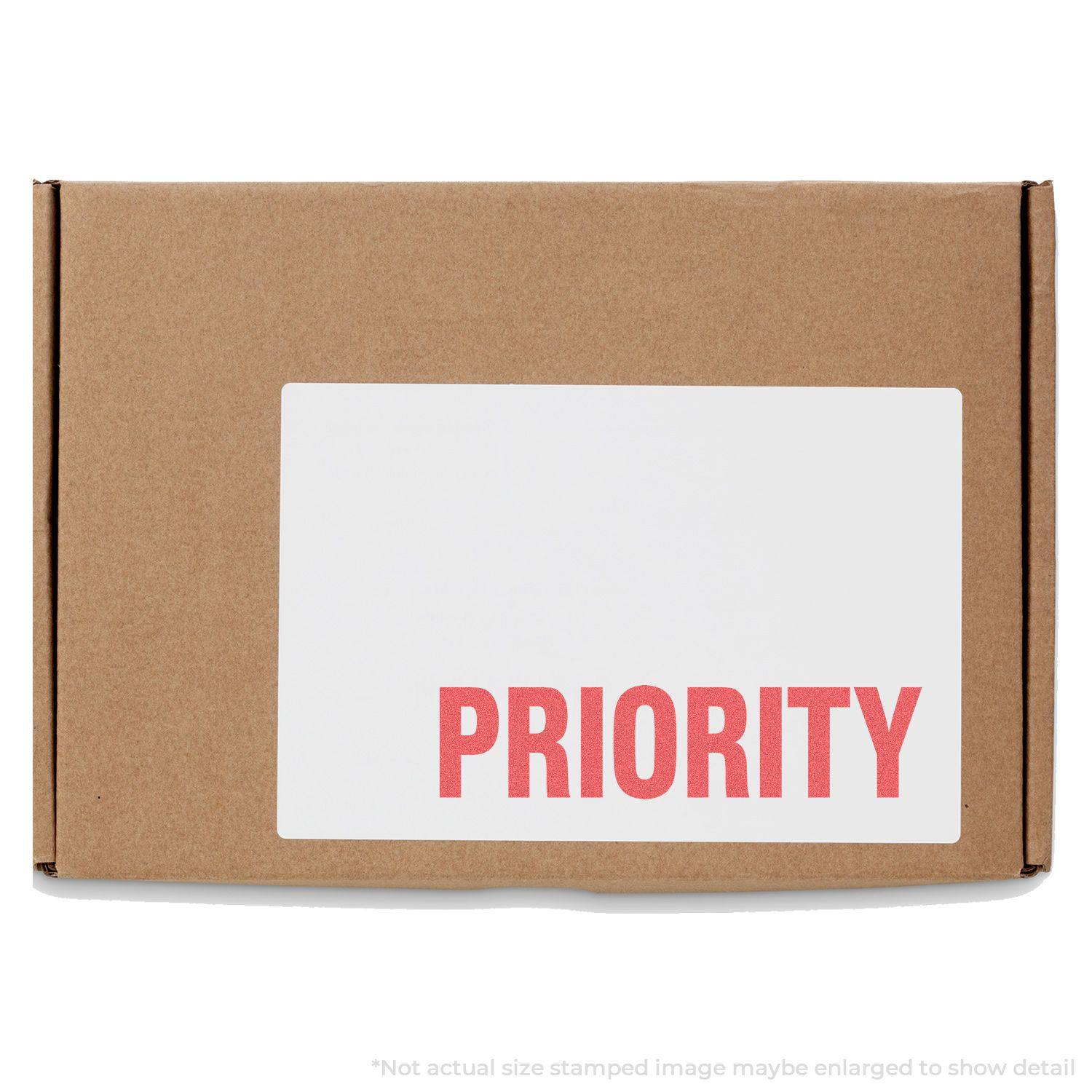 A cardboard box with a white label stamped PRIORITY in red using the Priority Xstamper Stamp.