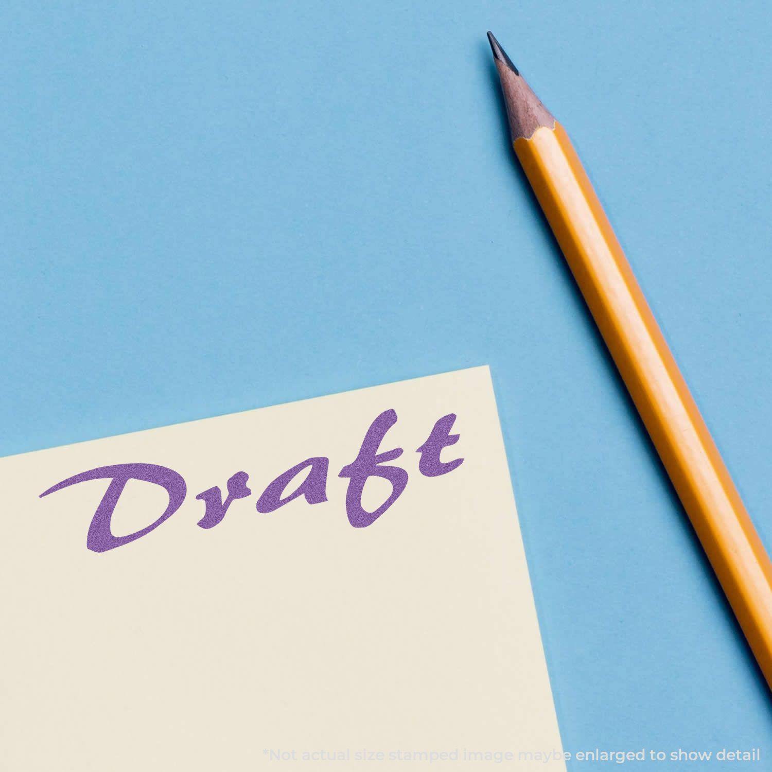 Purple Draft Xstamper Stamp imprint on paper next to a sharpened yellow pencil on a blue background.