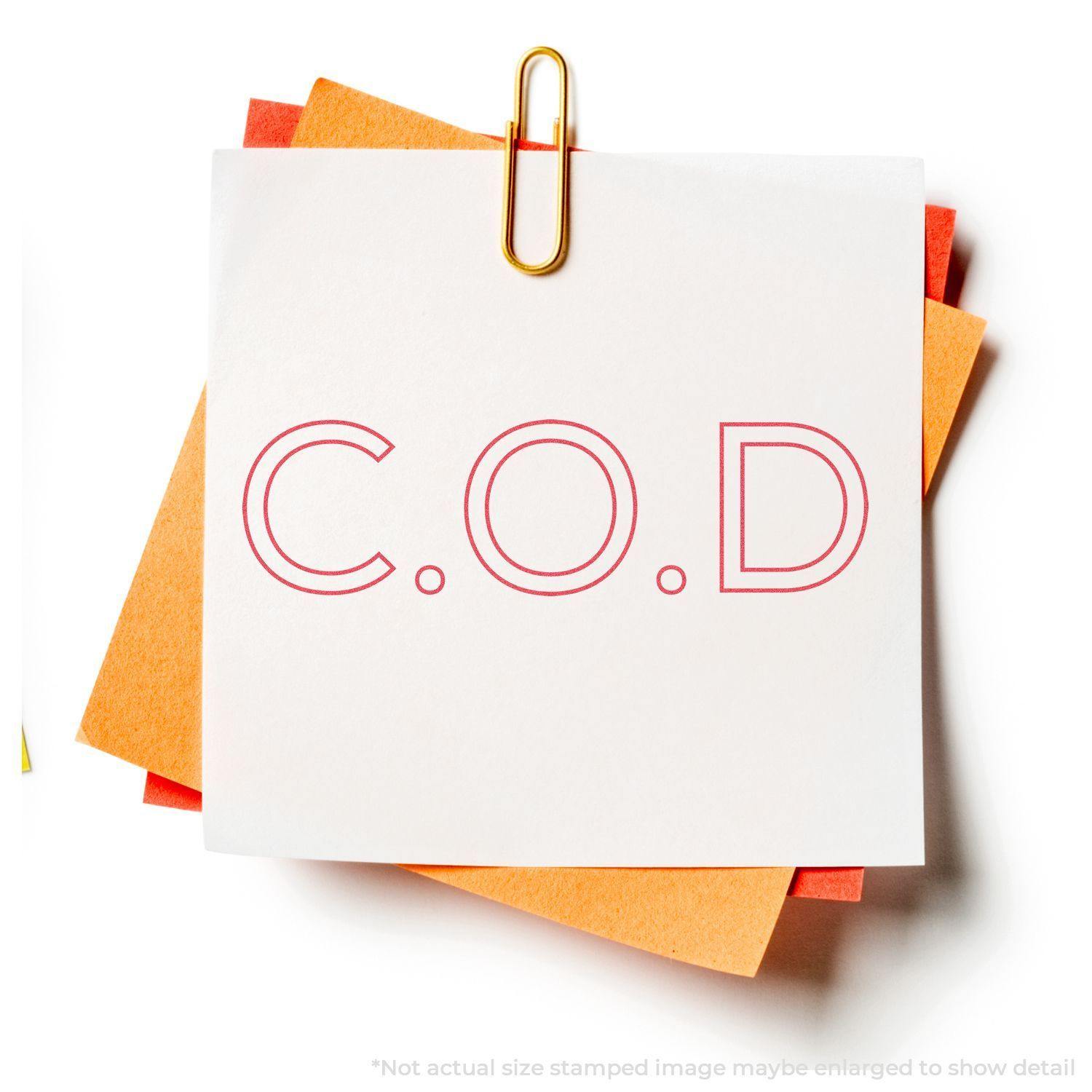 An xstamper stamp with a stamped image showing how the text "C.O.D" in an outline font is displayed after stamping.