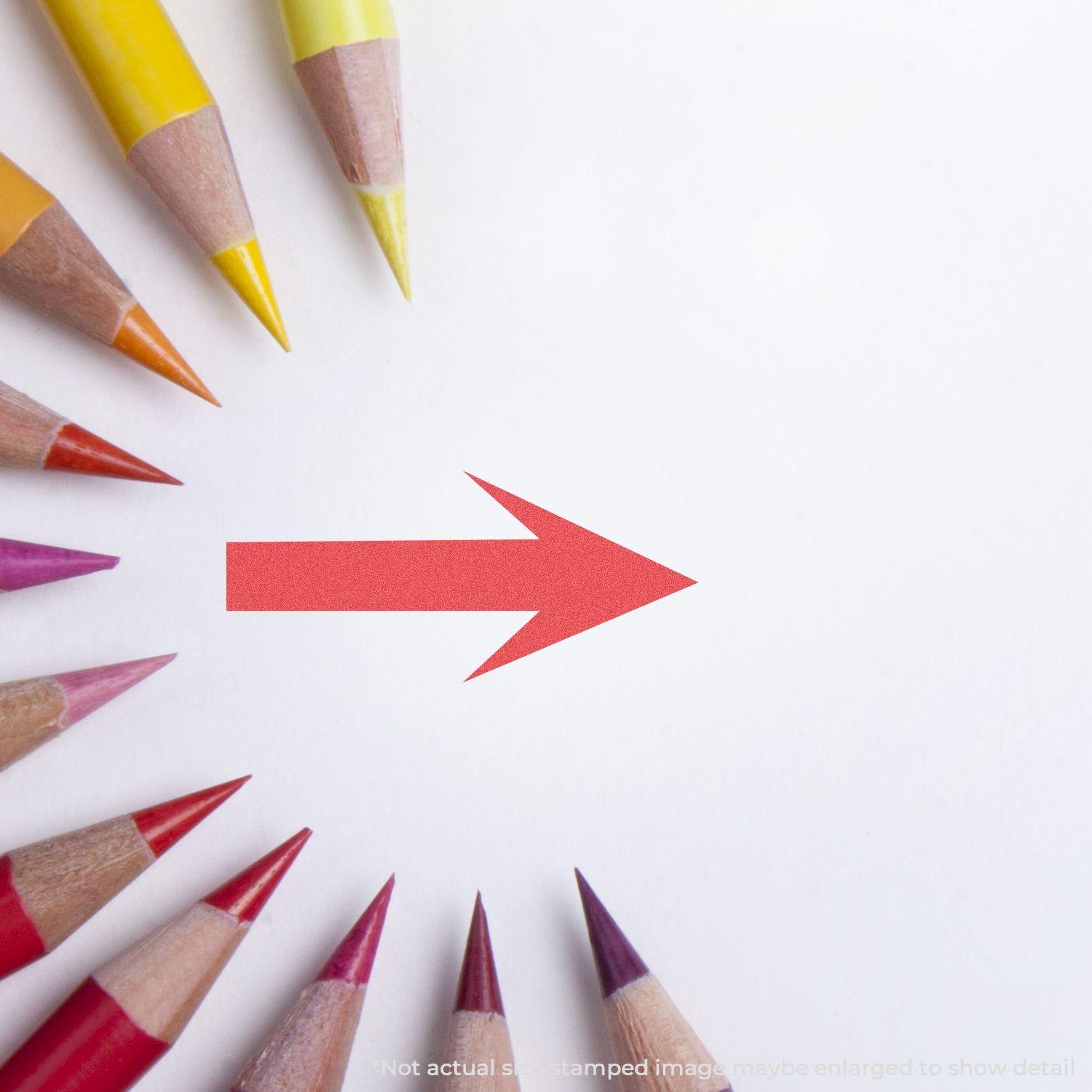 Colored pencils arranged in a circle pointing to a red arrow stamped on white paper using the Round Arrow Xstamper Stamp.