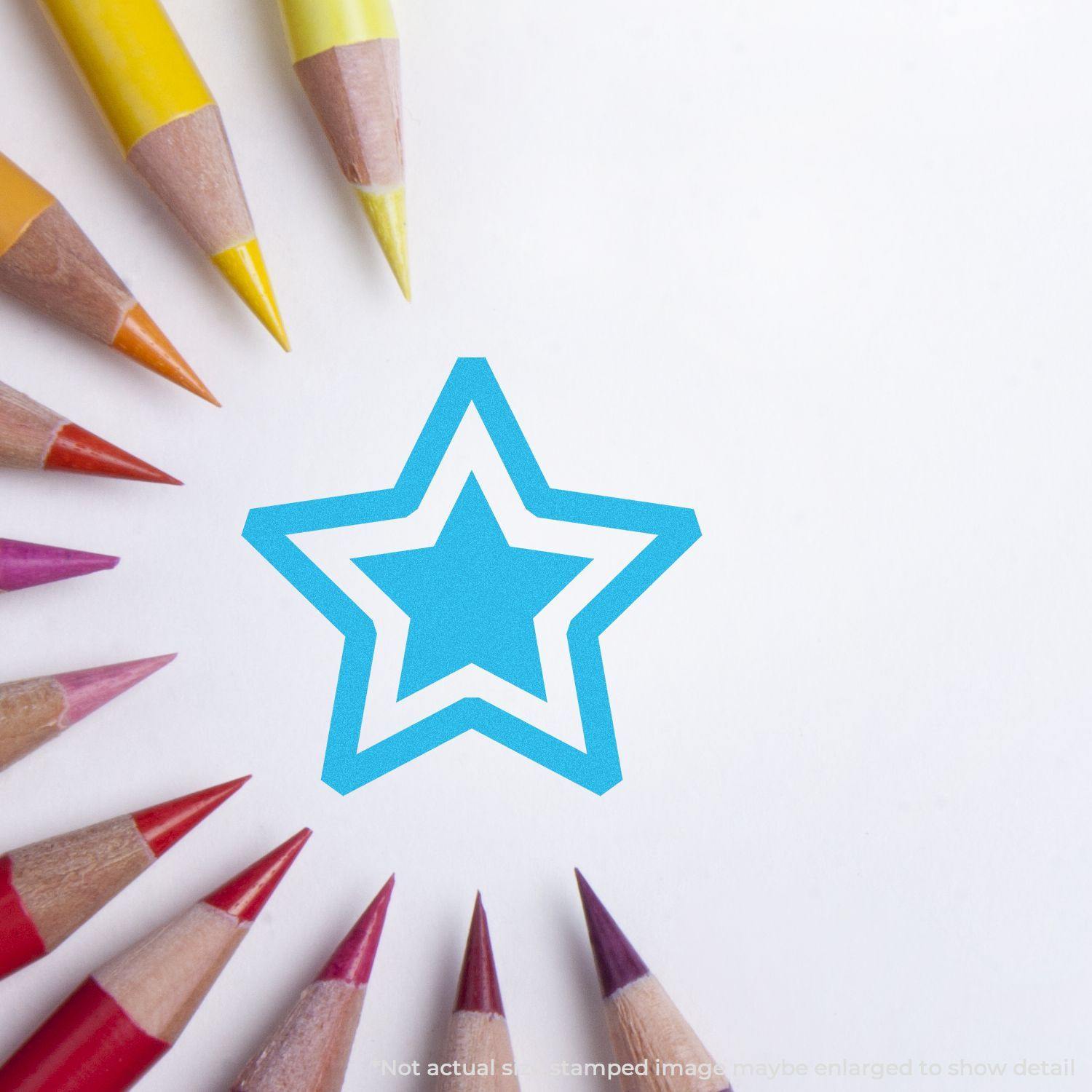 Round Blue Star Xstamper Stamp imprint on white paper, surrounded by colorful pencils arranged in a circle.