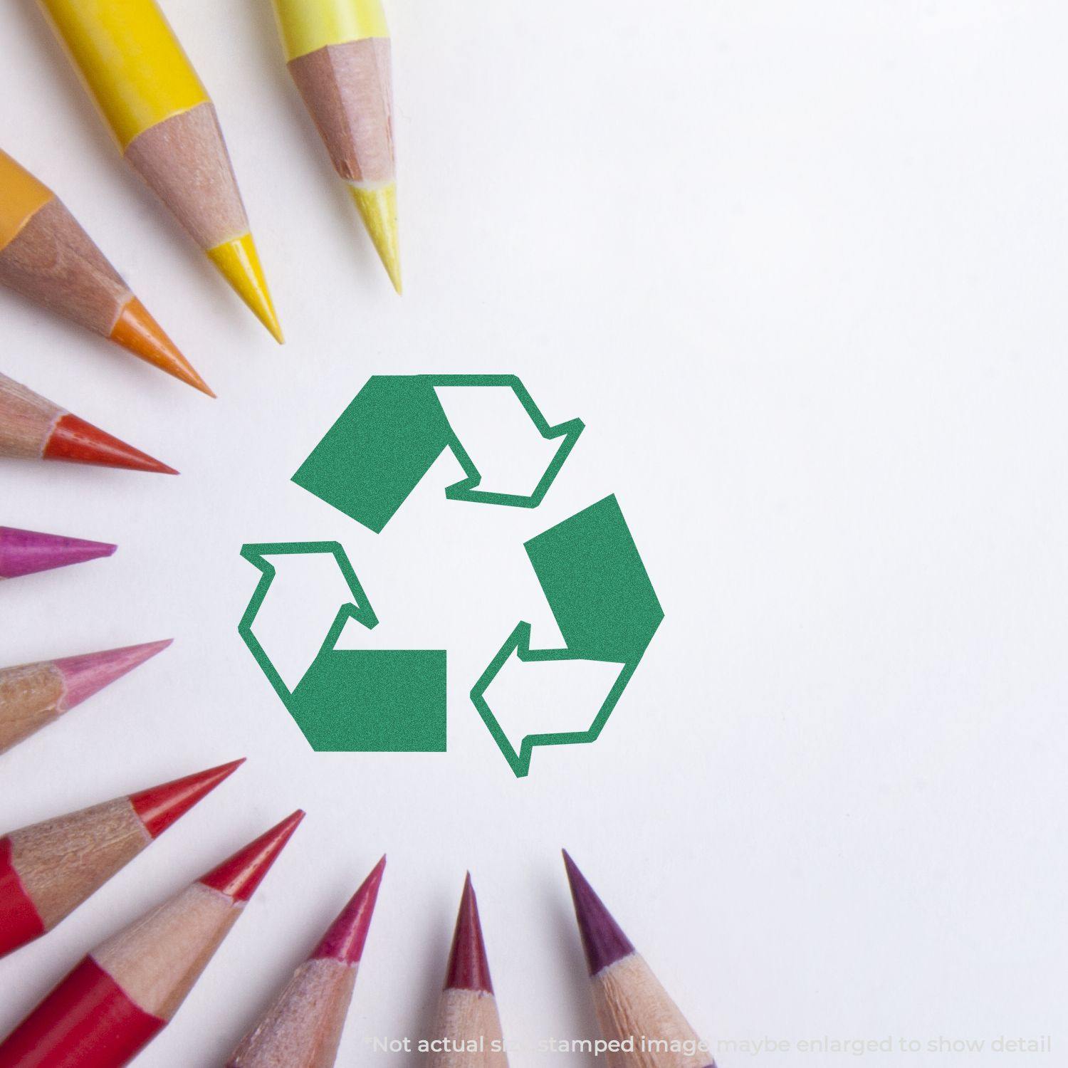 Round Recycle Logo Xstamper Stamp impression on white paper, surrounded by colorful pencils arranged in a circular pattern.