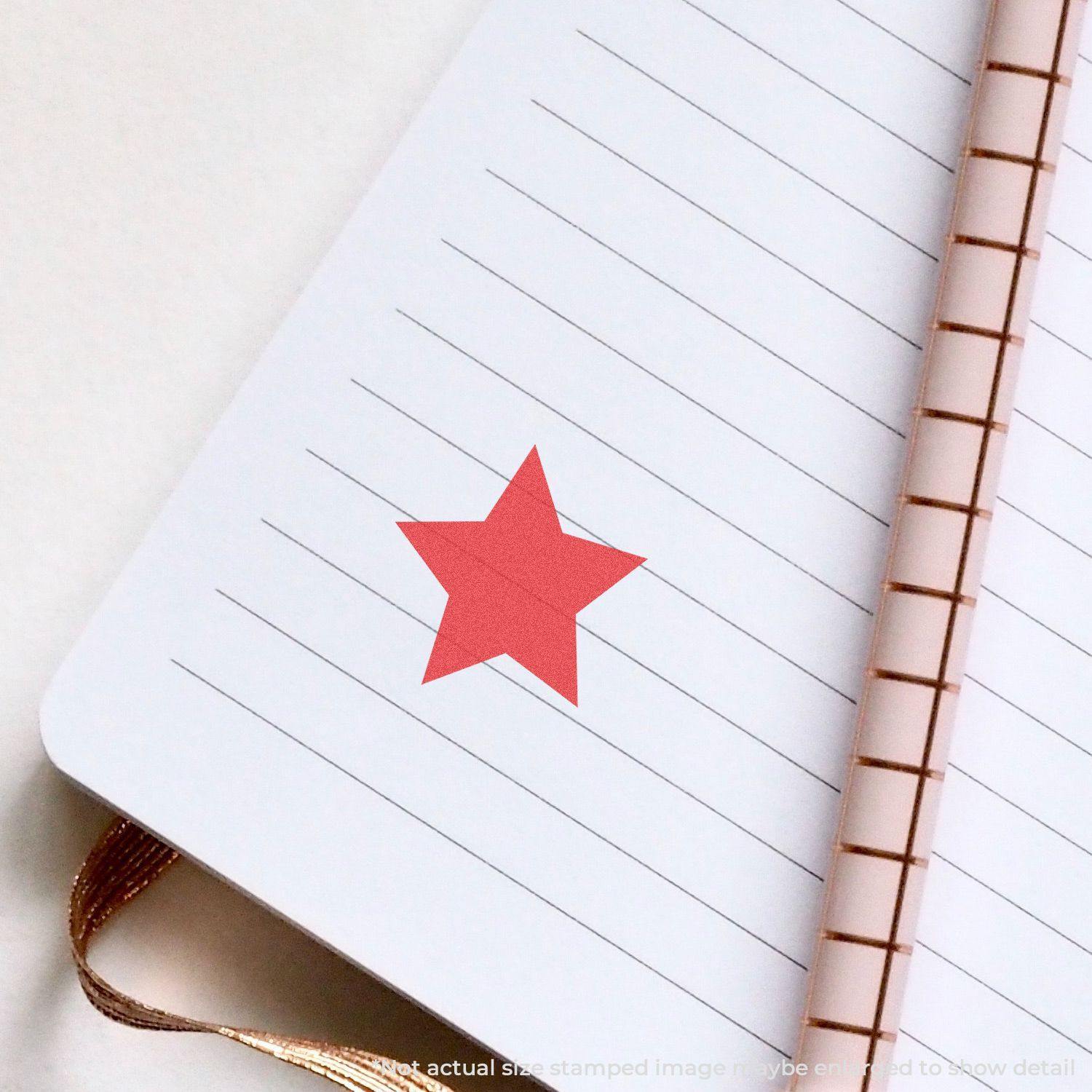 Round Red Star Xstamper Stamp imprint on a lined notebook page with a spiral binding.