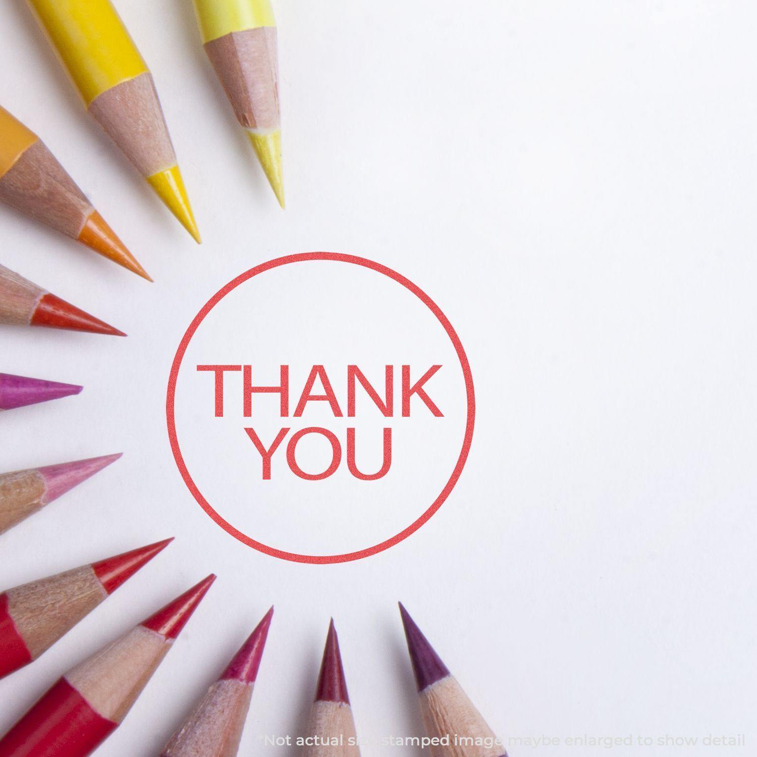 Round Red Thank You Xstamper Stamp impression on white paper, surrounded by colored pencils arranged in a circular pattern.