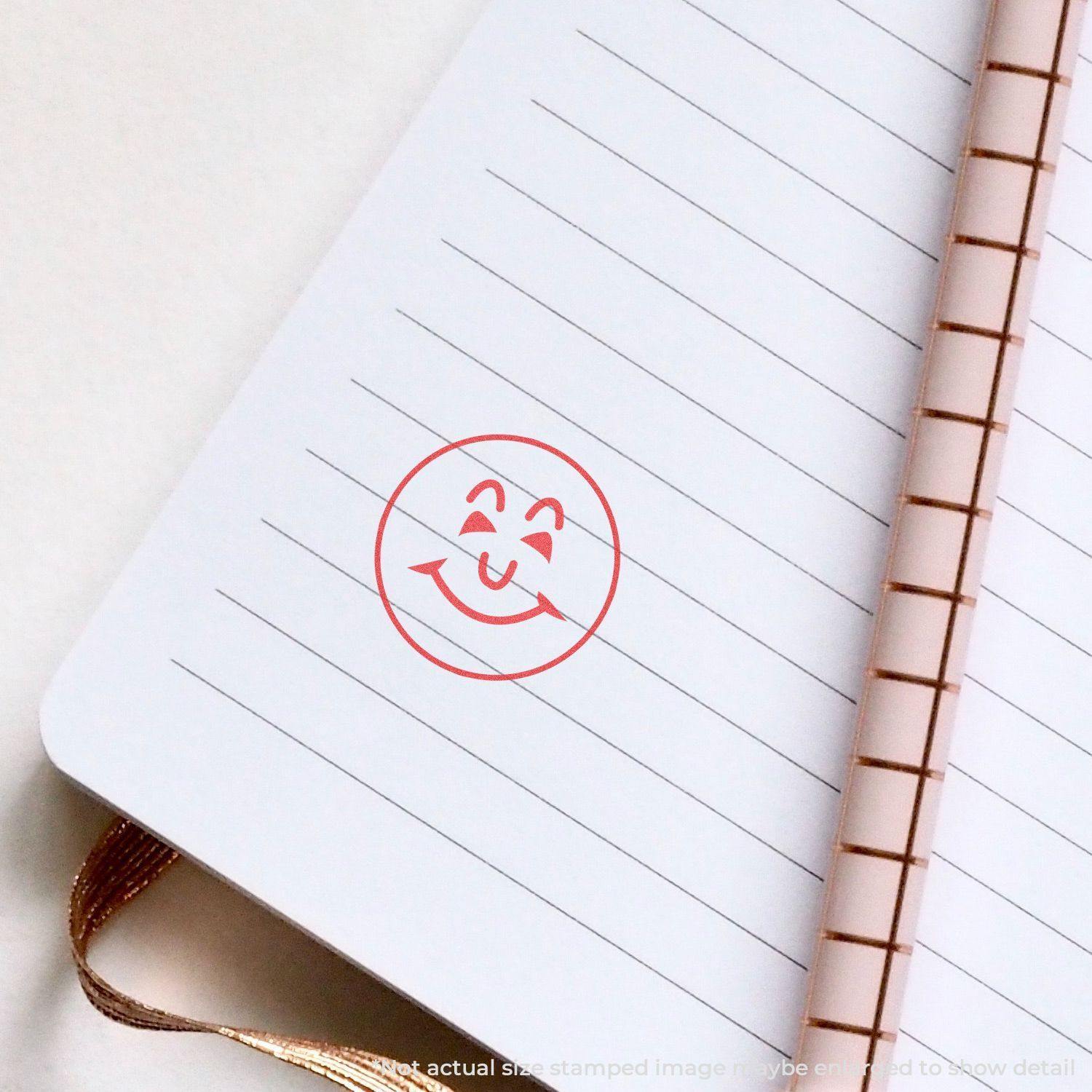 Round Smiley Face Xstamper Stamp in red ink on a lined notebook page with a spiral binding.