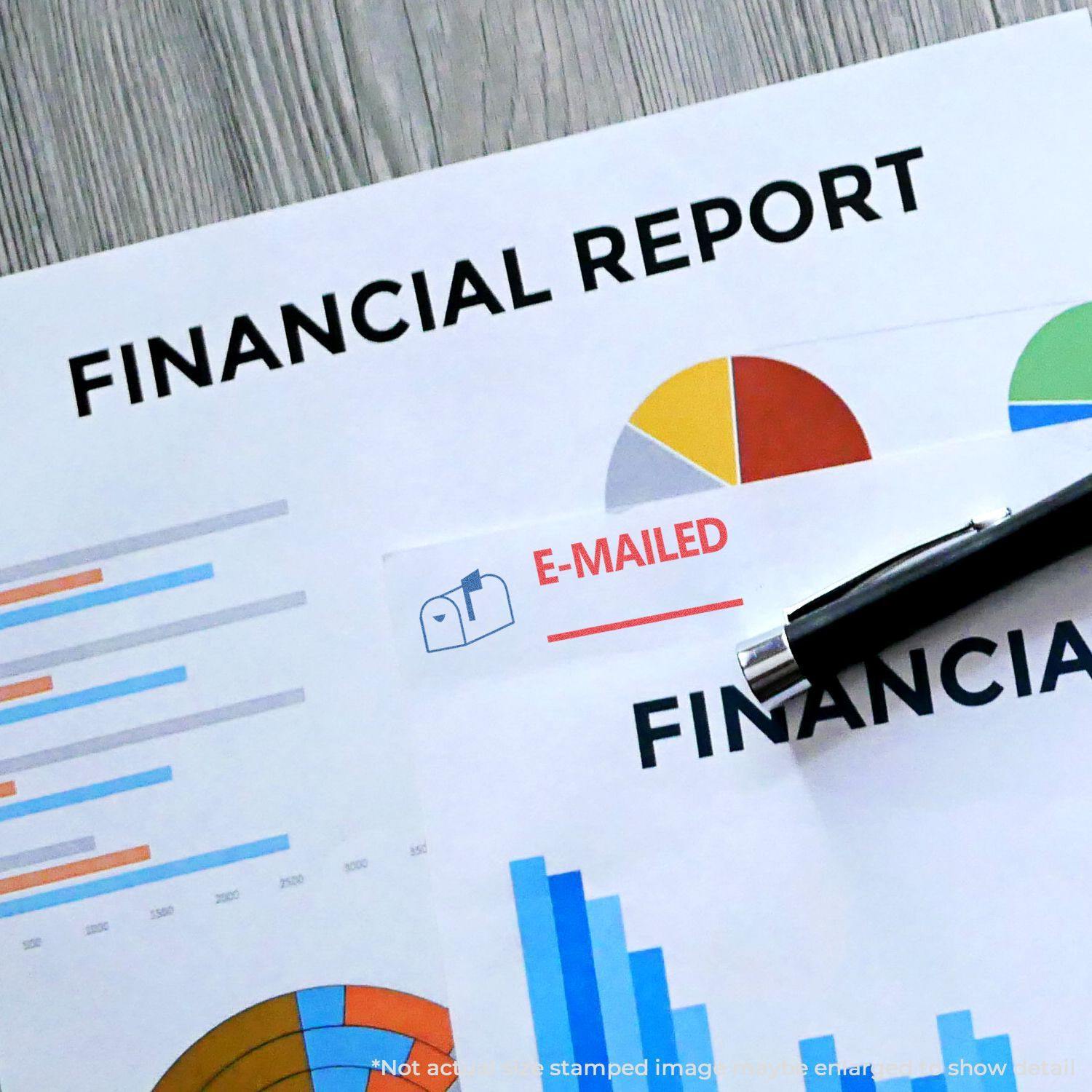 Two-Color Emailed Xstamper Stamp used on financial reports with charts and graphs, alongside a pen on a wooden desk.